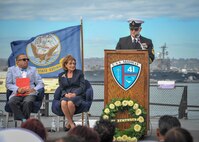Retired Senior Chief Hull Technician Chris Regal, a survivor of the bombing of the Arleigh Burke-class guided missile destroyer USS Cole (DDG-67), delivers remarks during a USS Cole Remembrance Ceremony aboard the USS Midway Museum in San Diego, Calif., Oct. 12, 2018.