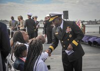 Rear Adm. Cedric E. Pringle, commander of Expeditionary Strike Group (ESG) 3, greets the family of Seaman Lakiba Palmer, a Sailor killed in the bombing of the Arleigh Burke-class guided-missile destroyer USS Cole (DDG 67),