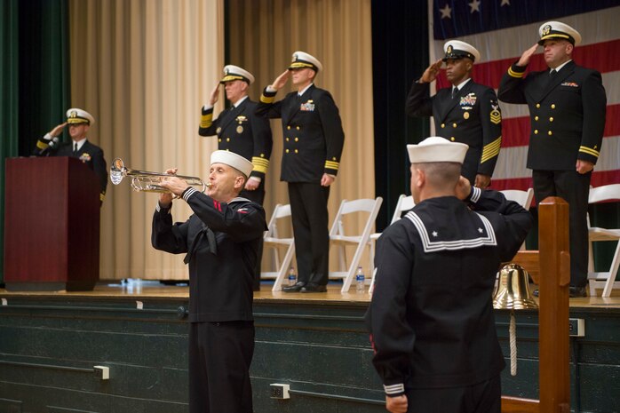 A Sailor plays taps during the USS Cole Remembrance Ceremony.