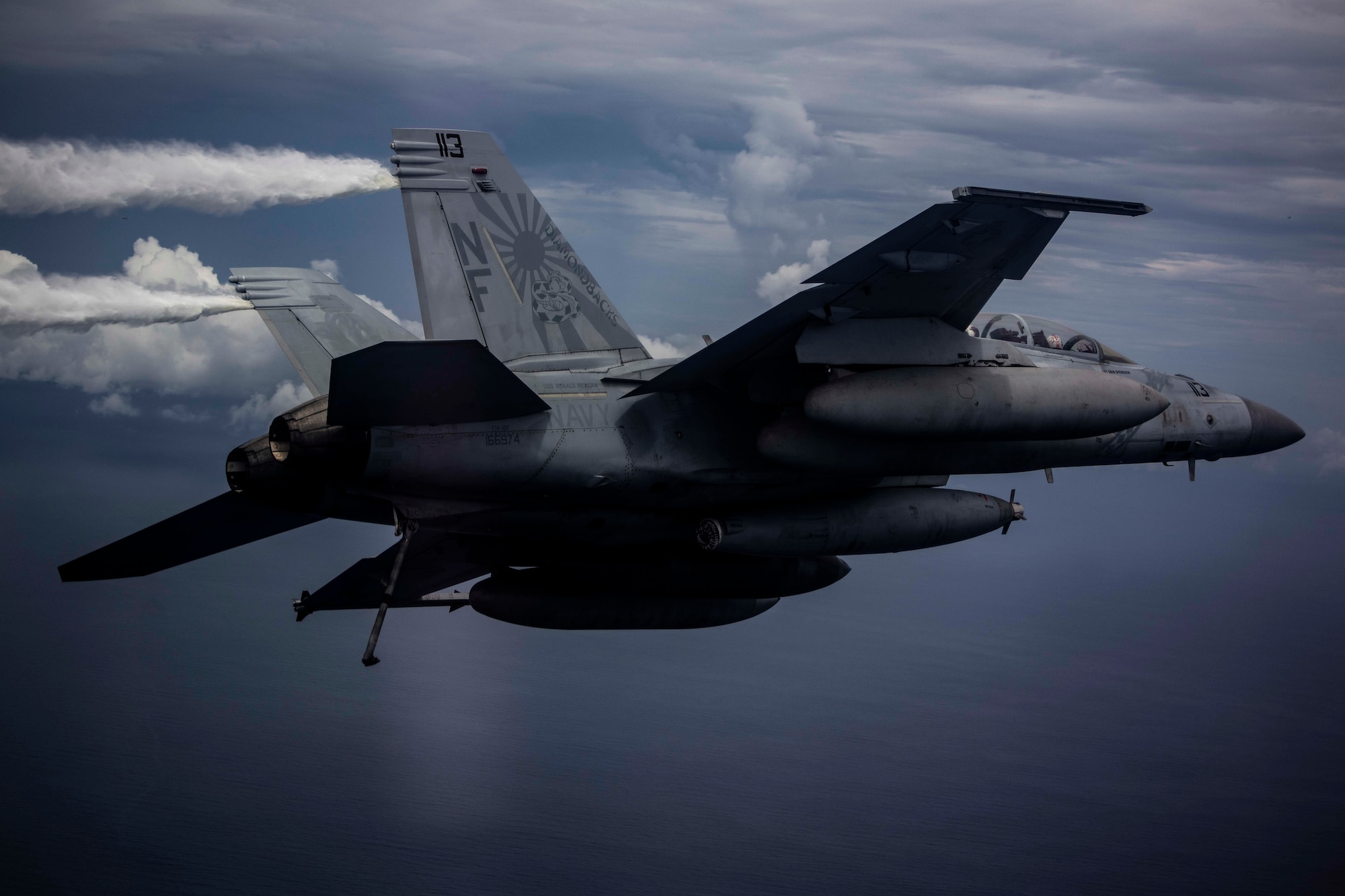 An F/A-18 Super Hornet attached to the “Diamondbacks” of Strike Fighter Squadron (VFA) 102 conducts air operations while flying with aircraft from the Nimitz Carrier Strike Force. The USS Nimitz (CVN 68) and USS Ronald Reagan (CVN 76) Carrier Strike Groups are conducting dual-carrier operations in the South China Sea as the Nimitz Carrier Strike Force. (U.S. Navy photo by Lt. Cmdr. Joseph Stephens)