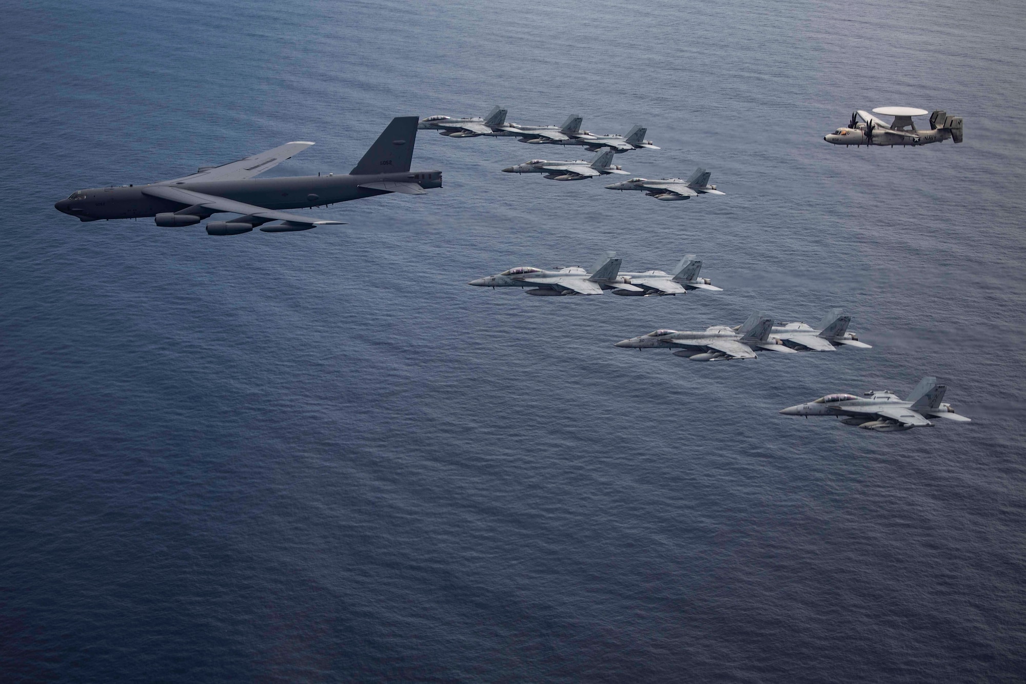 Aircraft from the Nimitz Carrier Strike Force and a B-52 Bomber from Barksdale Air Force base conduct integrated joint air operations in support of a free and open Indo-Pacific. The USS Nimitz (CVN 68) and USS Ronald Reagan (CVN 76) Carrier Strike Groups are conducting dual-carrier operations in the South China Sea as the Nimitz Carrier Strike Force. (U.S. Navy photo by Lt. Cmdr. Joseph Stephens)