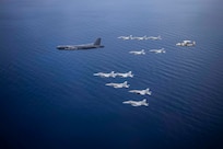 Aircraft from the Nimitz Carrier Strike Force and a B-52 Bomber from Barksdale Air Force base conduct integrated joint air operations in support of a free and open Indo-Pacific. The USS Nimitz (CVN 68) and USS Ronald Reagan (CVN 76) Carrier Strike Groups are conducting dual-carrier operations in the South China Sea as the Nimitz Carrier Strike Force. (U.S. Navy photo by Lt. Cmdr. Joseph Stephens)
