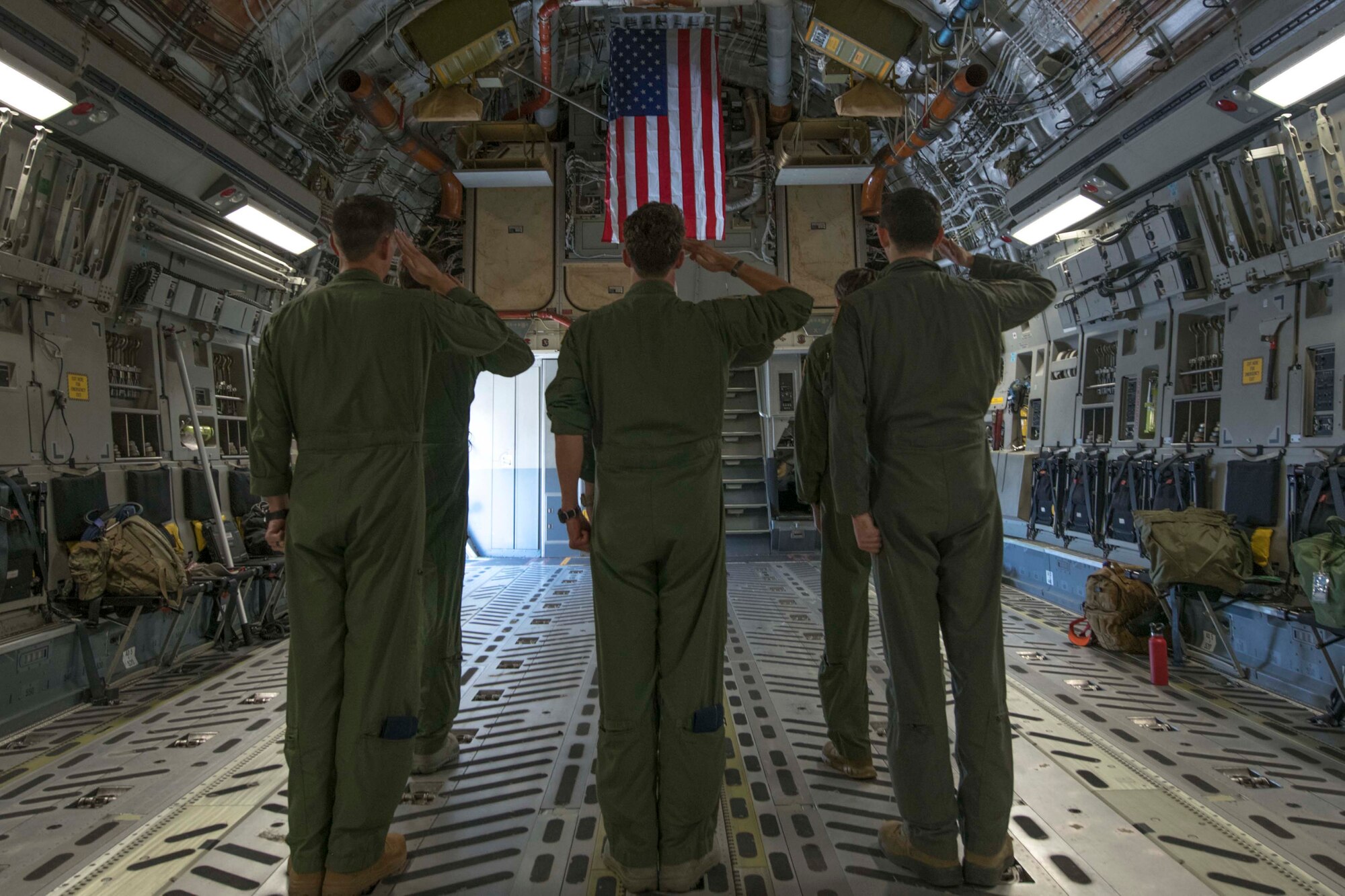 Members of Team Charleston salute the flag in honor of fallen Air Force Hero 1st Lt. David Schmitz, pilot, 77th Fighter Squadron, Shaw Air Force Base on July 4, 2020 at Joint Base Charleston, S.C. The flight down the coast was part of Salute from the Shore, but also to honor the fallen pilot.