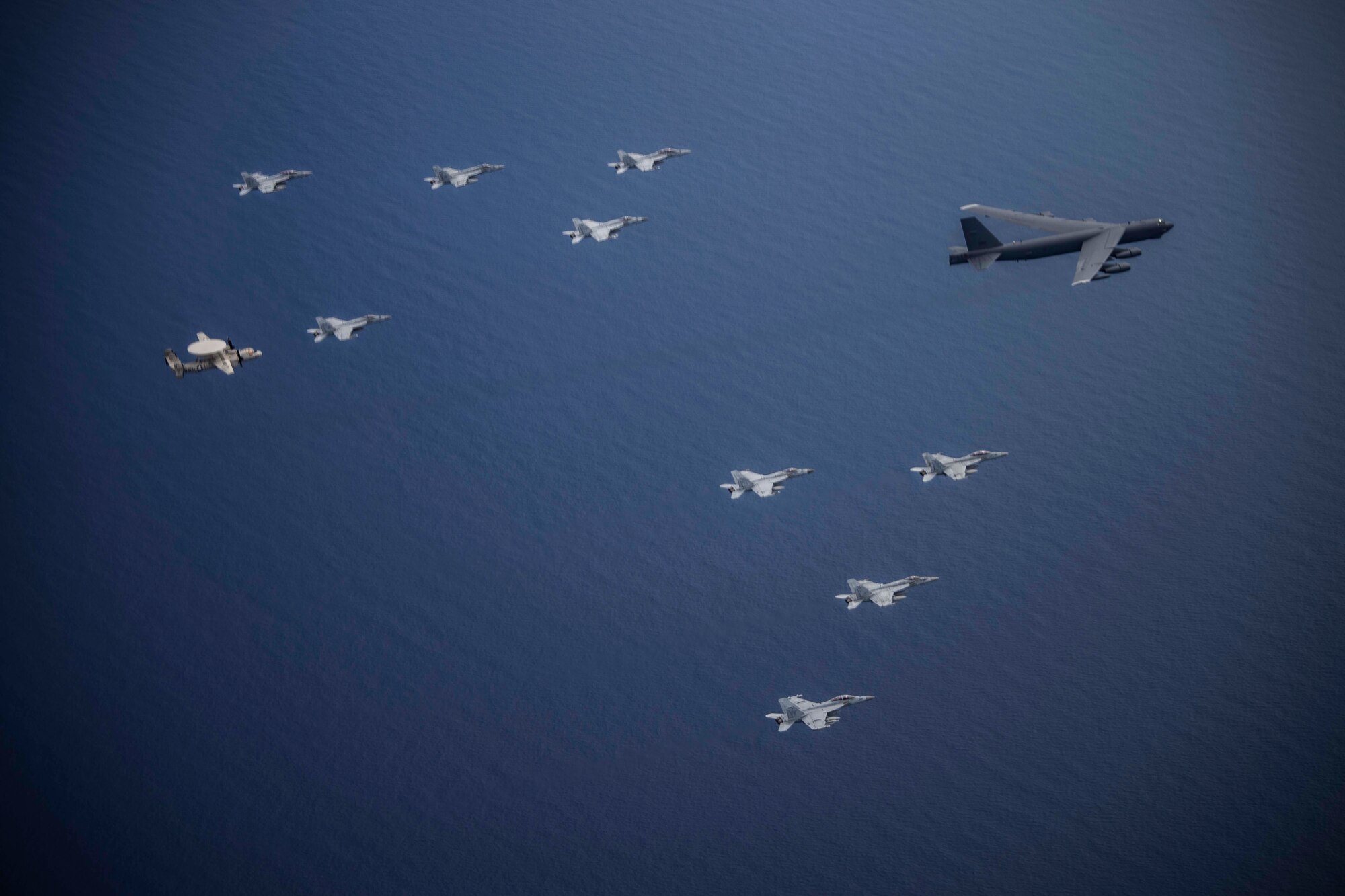 Aircraft from the Nimitz Carrier Strike Force and a B-52 Bomber from Barksdale Air Force base conduct integrated joint air operations in support of a free and open Indo-Pacific. The USS Nimitz (CVN 68) and USS Ronald Reagan (CVN 76) Carrier Strike Groups are conducting dual-carrier operations in the South China Sea as the Nimitz Carrier Strike Force. (U.S. Navy photo by Lt. Cmdr. Joseph Stephens)