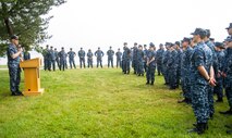 Rear Adm. Christopher Grady, Commander, Naval Surface Force Atlantic, left, speaks with midshipmen at the USS Cole Memorial aboard Naval Station Norfolk as part of the U.S. Naval Academy's 2016 Professional Training for Midshipmen (PROTRAMID) Surface Week.