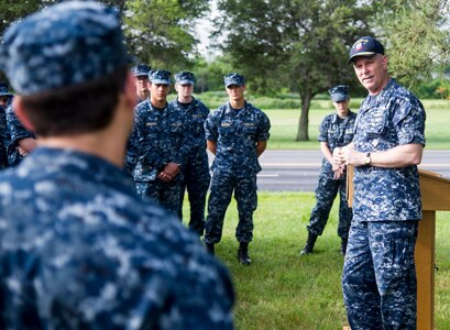 Rear Adm. Christopher Grady, Commander, Naval Surface Force Atlantic, right, speaks with midshipmen at the USS Cole Memorial aboard Naval Station Norfolk as part of the U.S. Naval Academy's 2016 Professional Training for Midshipmen (PROTRAMID) Surface week.