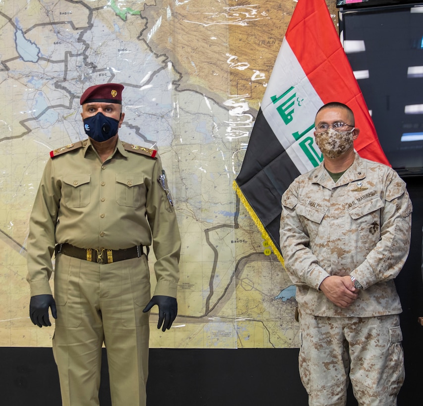 Iraqi Staff Lt. Gen. Abd al-Amir al-Shammari (left), deputy commander of the Joint Operations Command for Iraq (JOC-I), addresses attendees gathered for the change-of-command ceremony signifying Combined Joint Task Force-Operation Inherent Resolve’s Task Force Iraq transition to the Military Advisory Group.