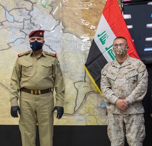Iraqi Staff Lt. Gen. Abd al-Amir al-Shammari (left), deputy commander of the Joint Operations Command for Iraq (JOC-I), addresses attendees gathered for the change-of-command ceremony signifying Combined Joint Task Force-Operation Inherent Resolve’s Task Force Iraq transition to the Military Advisory Group.