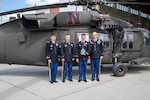 From left, Chief Warrant Officer 2 Nathan Dooley, pilot; Sgt. Aaron Winberg, crew chief; Chief Warrant Officer 3 Josh Schaaf, pilot-in-command; and Staff Sgt. Lawrence Lind, combat medic, with the DUSTOFF 2019 Rescue of the Year award. Flying the Nebraska Army National Guard UH-60 Black Hawk helicopter behind them the evening of March 14, 2019,  they rescued seven first responders from floodwaters near the Elkhorn River.
