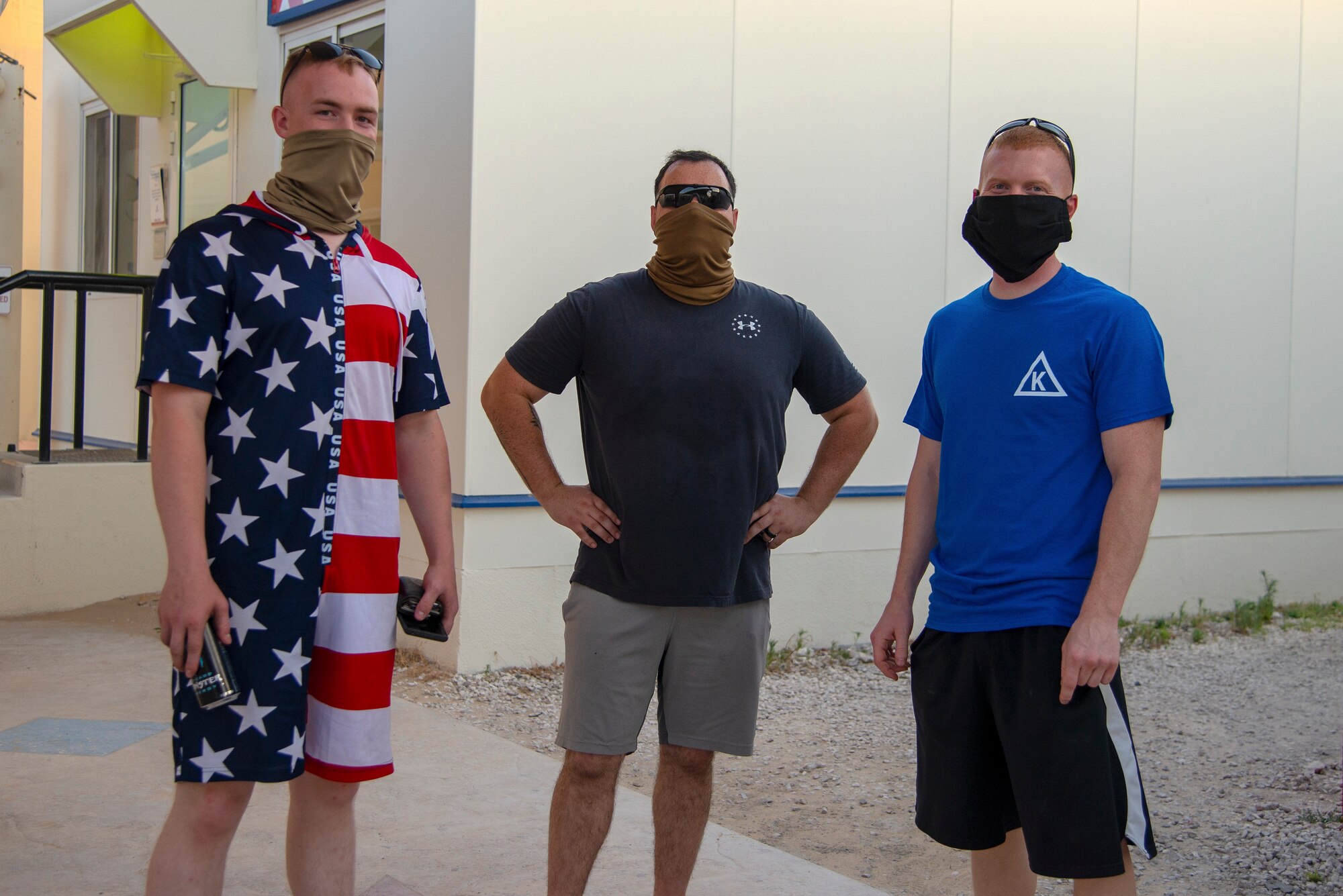 379th Expeditionary Maintenance Squadron Aerospace Ground Equipment members Senior Airman Jeffery Pentland (left), Staff Sgt. Jake Stevens (middle) and Tech. Sgt. Kevin Lurbbert pose for a photo, July 4, 2020, Al Udeid Air Base, Qatar. Service members across the installation attended events such as a bean bag toss tournament, a talent show and free food service at the Fox Sports Bar.