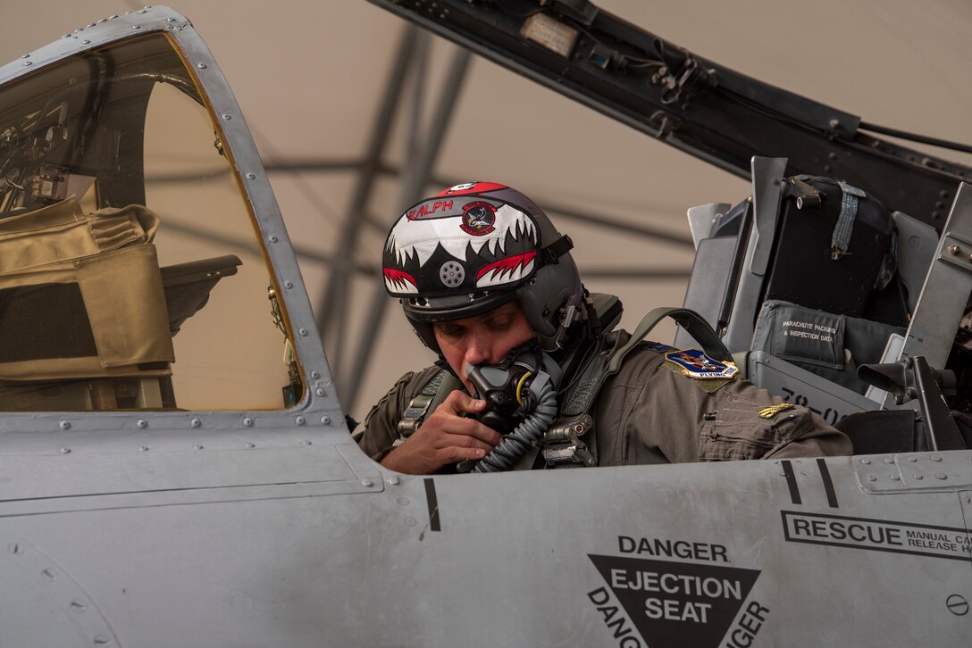 A photo of a pilot speaking into a helmet microphone