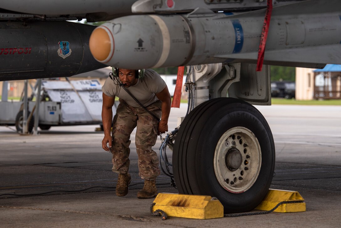 An Airman performs pre-flight checks.
