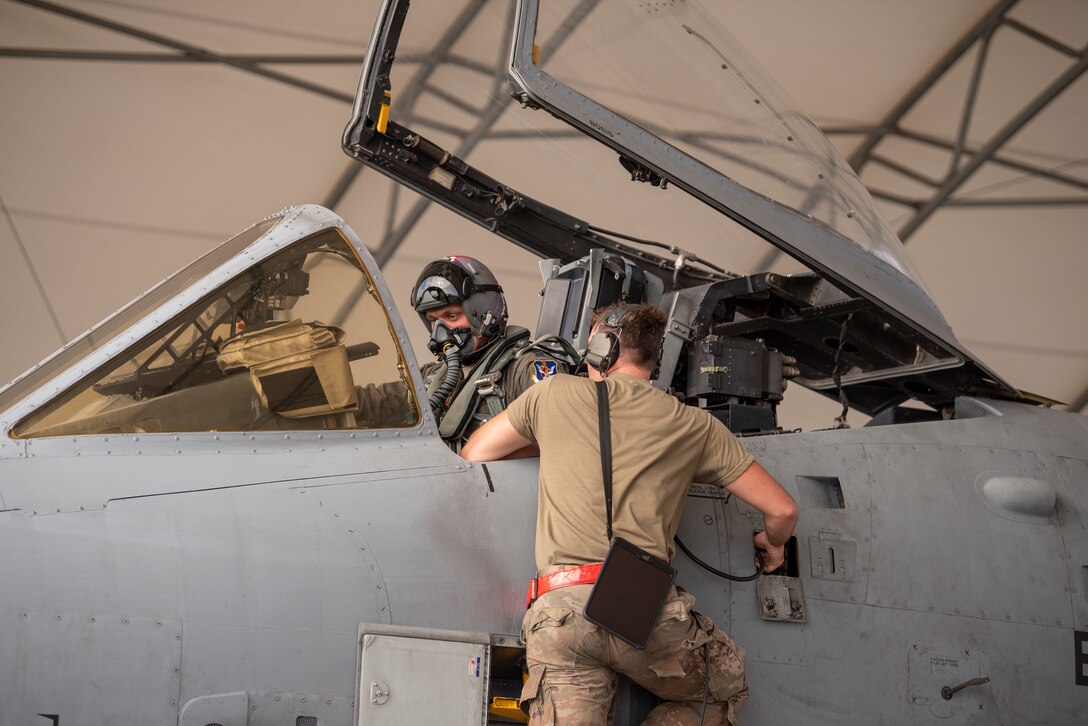 A photo of an Airmen troubleshooting an aircraft maintenance issue.