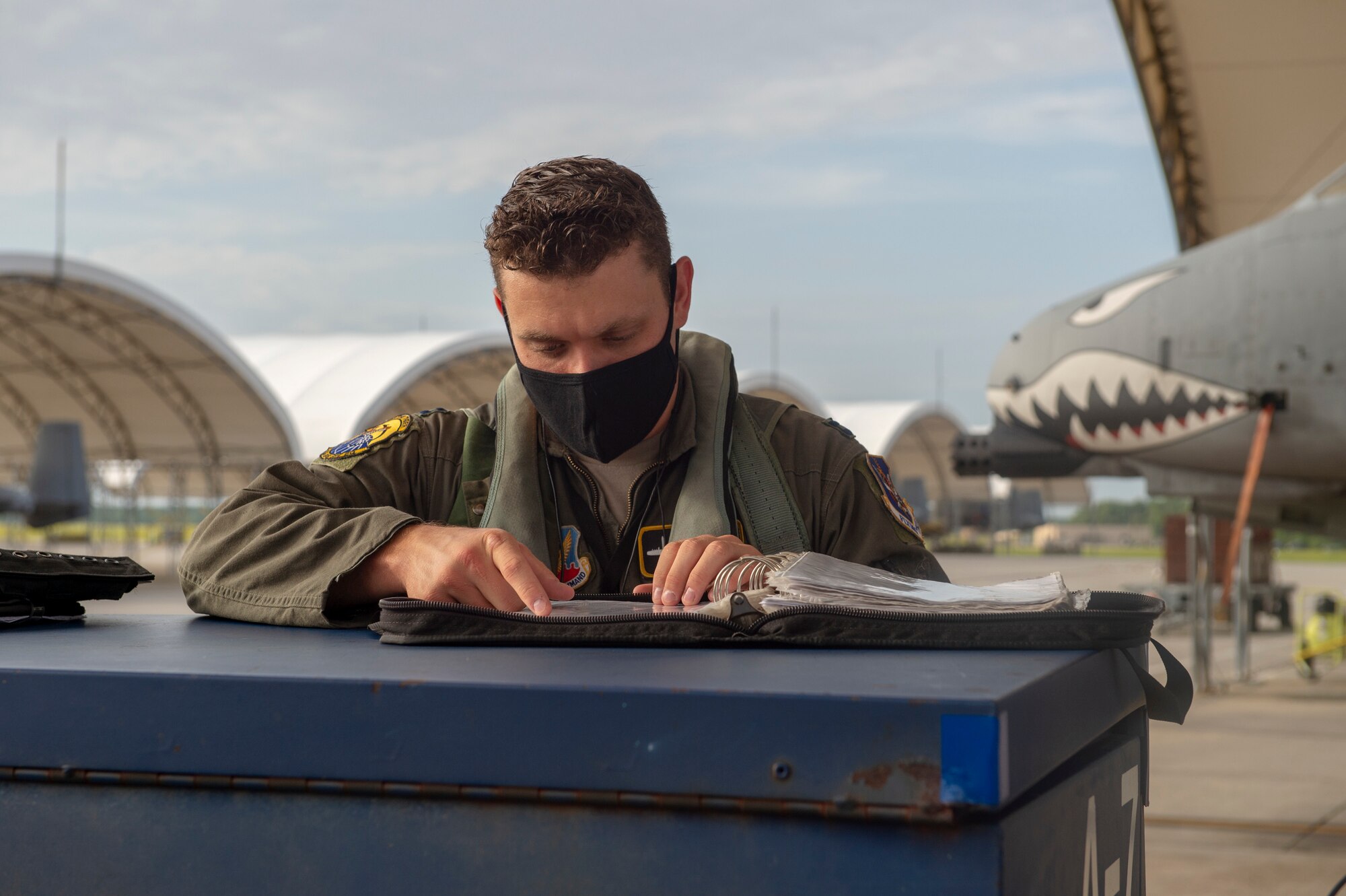 A photo of a pilot checking flight manual