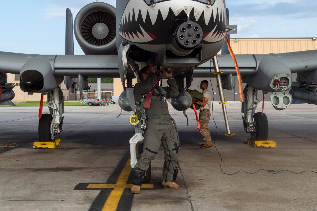 A photo of a pilot performing preflight checks