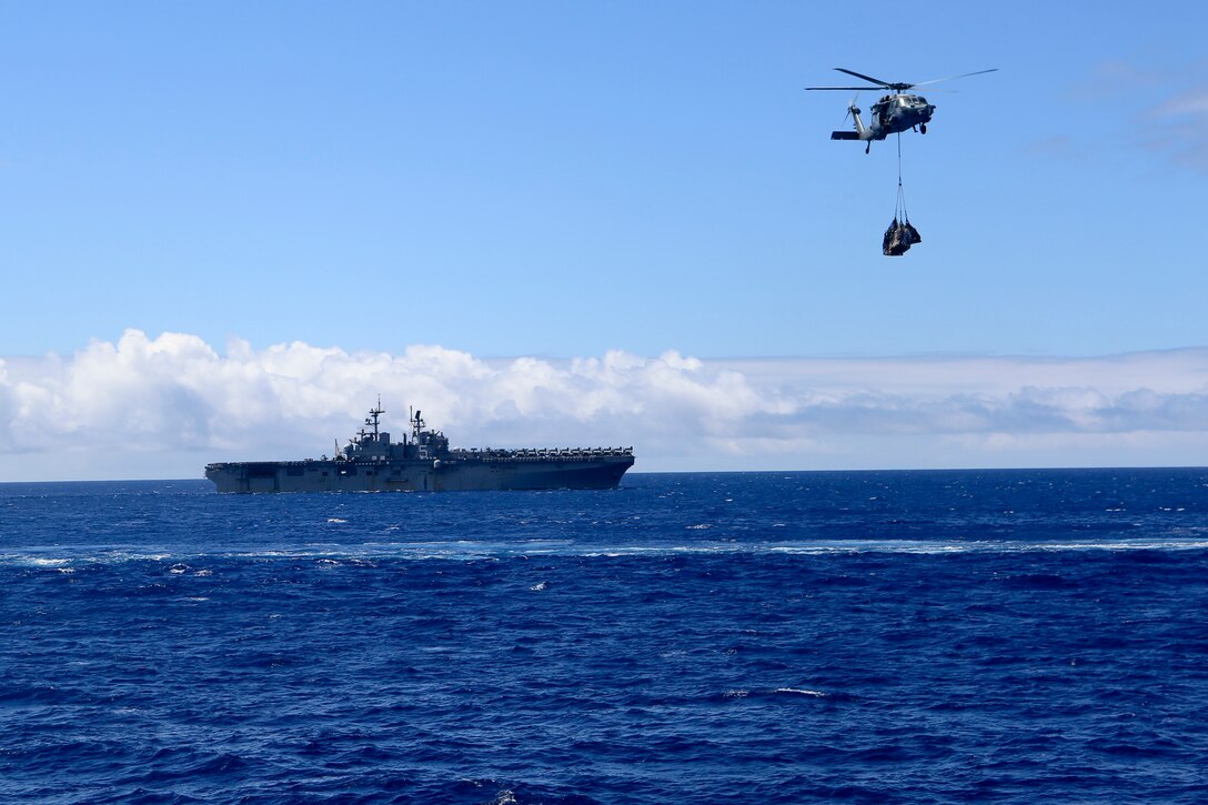 200702-M-CB805-1006 ATLANTIC OCEAN (July 2, 2020) The amphibious assault ship USS Bataan (LHD 5) transits alongside the amphibious dock landing ship USS Oak Hill (LSD 51) during a vertical replenishment-at-sea July 2, 2020. 26th Marine Expeditionary Unit is conducting operations in U.S. 6th Fleet in support of regional allies and partners, and U.S. national security interests in Europe and Africa.  (U.S. Marine Corps photo by Staff Sgt. Pablo D. Morrison/Released)