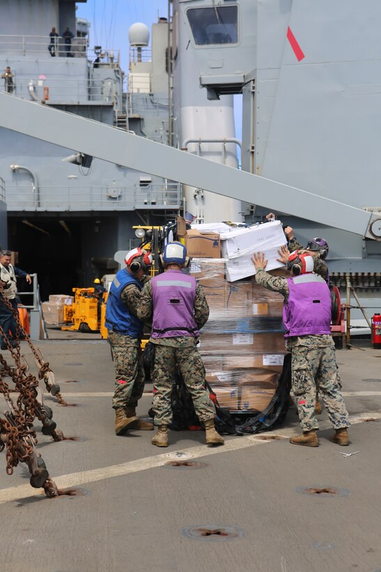 200702-M-CB805-1026 ATLANTIC OCEAN (July 2, 2020) Marines assigned to Combat Logistics Battalion 26, 26th Marine Expeditionary Unit (MEU), unpack supplies during a vertical replenishment-at-sea aboard the amphibious dock landing ship USS Oak Hill (LSD 51) July 2, 2020. 26th MEU is conducting operations in U.S. 6th Fleet in support of regional allies and partners, and U.S. national security interests in Europe and Africa.  (U.S. Marine Corps photo by Staff Sgt. Pablo D. Morrison/Released)