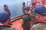 military officers aboard a single point mooring buoy