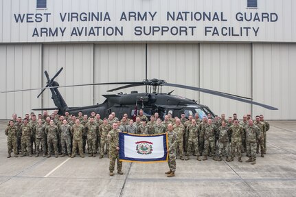 Members of the Charlie Company, 2nd General Support Battalion, 104th Aviation Regiment, (2-104th GASB) pose for a photo at the West Virginia National Guard Army Aviation Support Facility in WIlliamstown, W.Va. More than 60 service members, including pilots, maintainers, flight medics and support staff, will deploy to support aviation operations within the Middle East area of responsibility.