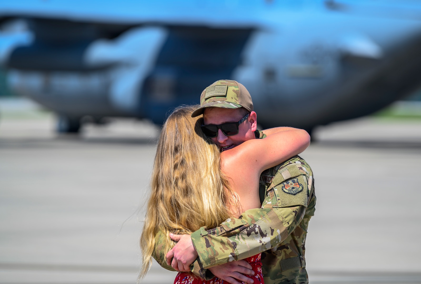 A member of the 130th Airlift Wing hugs a family member upon returning from an overseas deployment July 4, 2020, at McLaughlin Air National Guard Base in Charleston, W.Va. More than 70 members of the 130th Airlift Wing returned from Kuwait where they provided support for C-130H operations in the Middle East Area of Responsibility. (U.S. Air National Guard photo by Master Sgt. De-Juan Haley)