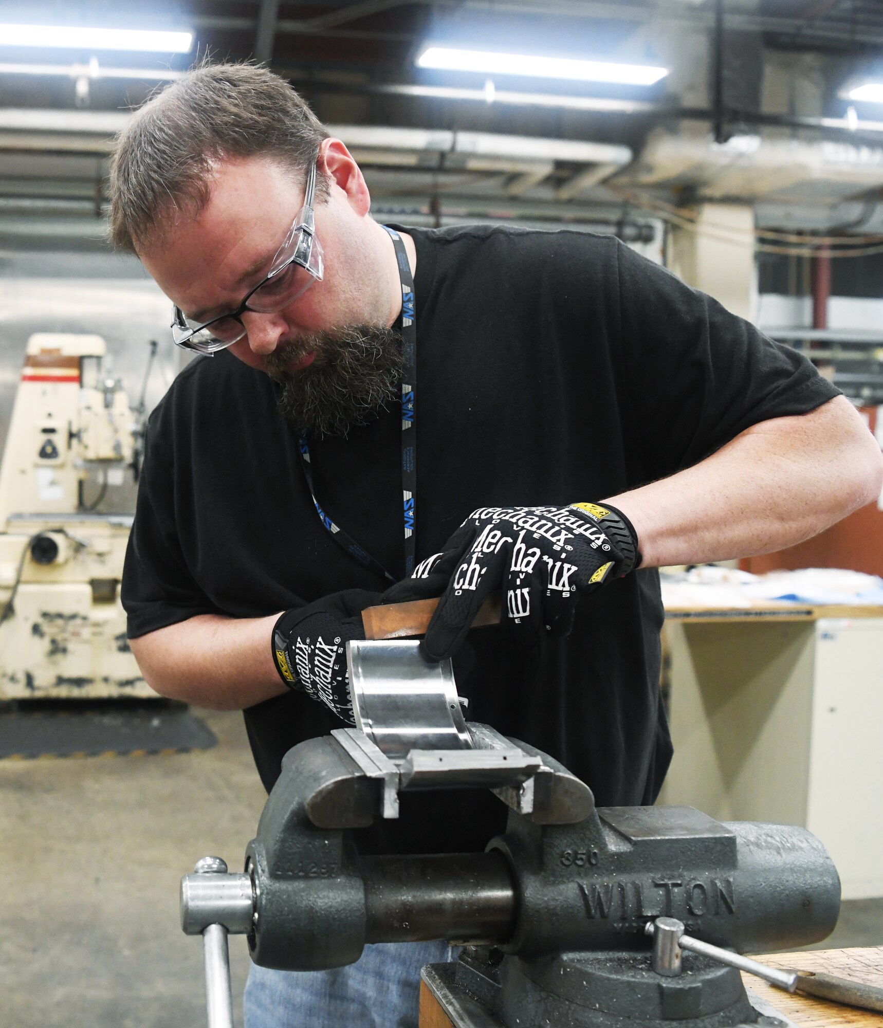 Will Hale Jr., an inside machinist, uses a hone on the section of a test facility part to fine tune the fit of it to another section May 5 in the Model & Machine Shop at Arnold Air Force Base.