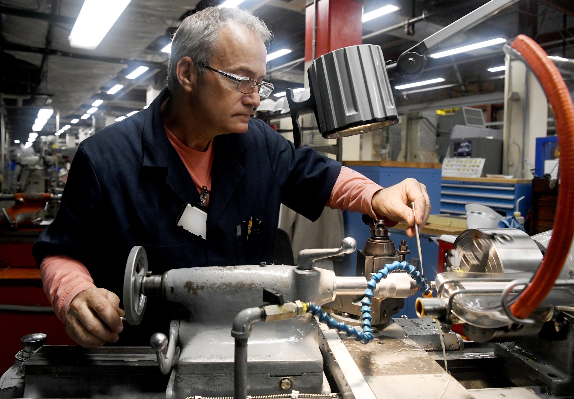 Ronnie Long, an inside machinist, works on a part for a test model May 5 in the Model & Machine Shop at Arnold Air Force Base. Arnold Engineering Development Complex craftsmen are continuing to work while maintaining social distance as a risk mitigation measure during the coronavirus pandemic. (U.S. Air Force photo by Jill Pickett) (This image was altered by obscuring a badge for security purposes.)