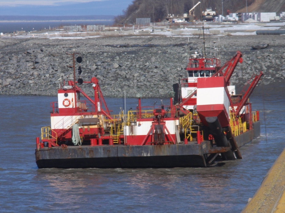 The Westport, a red and white hopper dredge operated by Manson Construction, dredges near the Port of Alaska on April 3, 2019.
