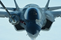 An aircraft connects to a fuel extender from another.
