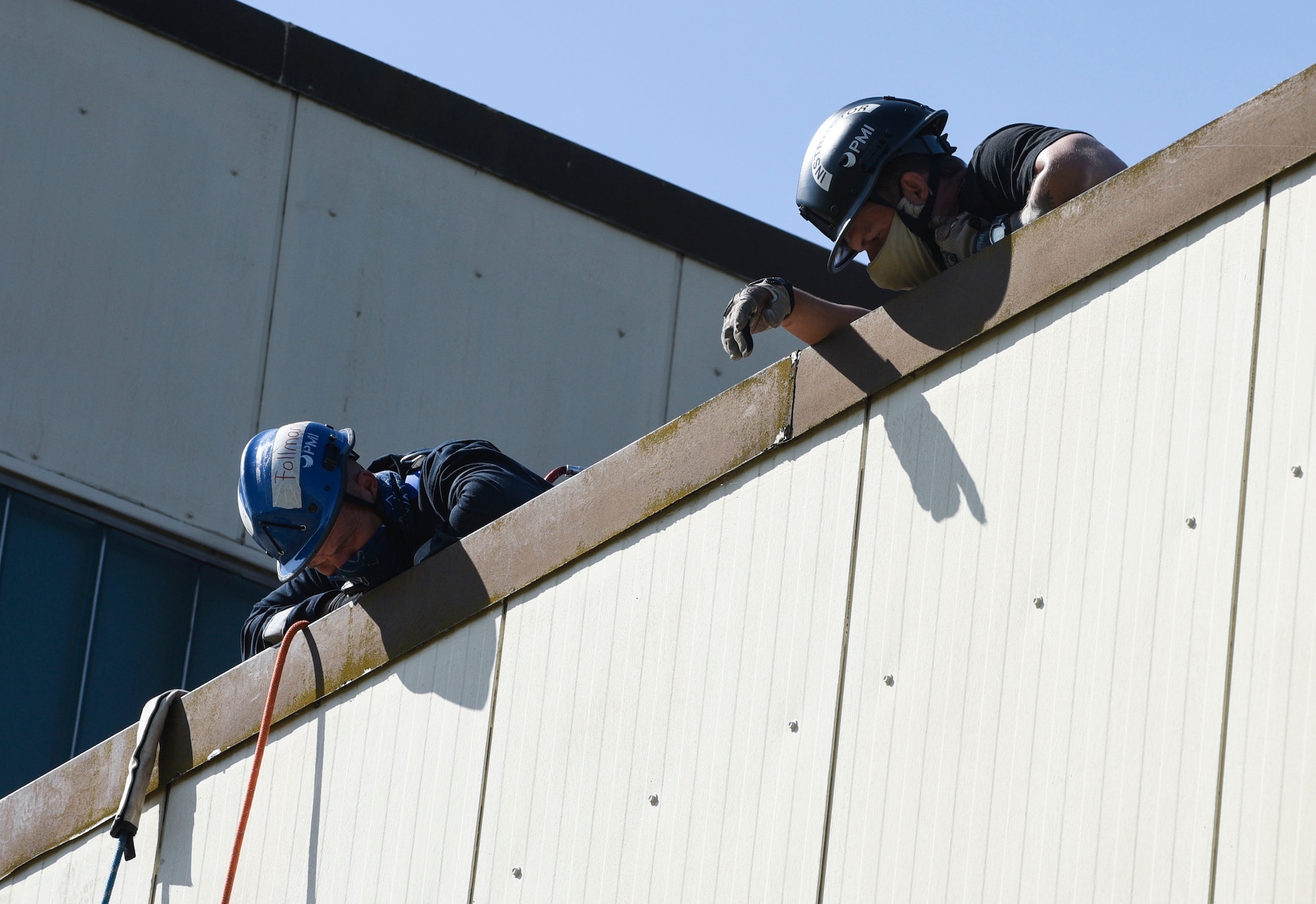 Marcel Follmann, 52nd Civil Engineer Squadron Fire and Emergency Services driver operator, left, and U.S Air Force Staff Sgt. Robert Welborn, 435th Construction and Training Squadron Fire Rescue and Contingency Training instructor, look at descending firefighters during a Rescue Technician course at Spangdahlem Air Base, Germany, June 23, 2020. Members from the 52 FES flight participate in this training to remain vigilant and ready to perform rescue operations in case of unexpected emergencies. (U.S. Air Force photo by Senior Airman Melody W. Howley)