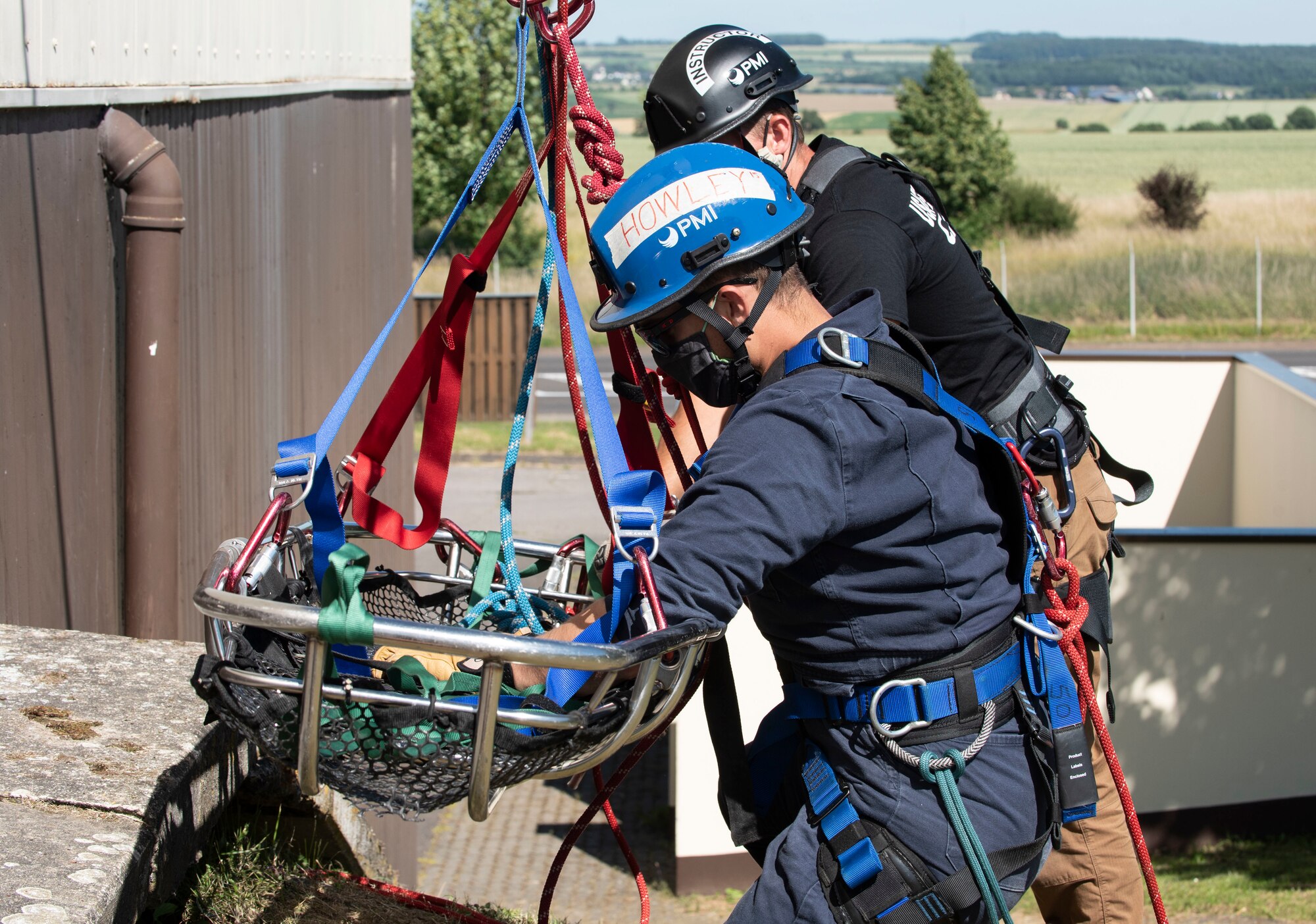 U.S. Air Force Staff Sgt. Sean Howley, front, 52nd Civil Engineer Squadron Fire and Emergency Services driver operator, front, practices ascending from a building while Staff Sgt. Robert Welborn, 435th Construction and Training Squadron Fire Rescue and Contingency Training instructor, ensures proper procedures and safety measures are followed at Spangdahlem Air Base, Germany, June 23, 2020. Some of the topics covered during the Rescue Technician course include knots, anchors, mechanical advantages, low angle rescues, rappelling, high lines, and confined space rescues. (U.S. Air Force photo by Senior Airman Melody W. Howley)