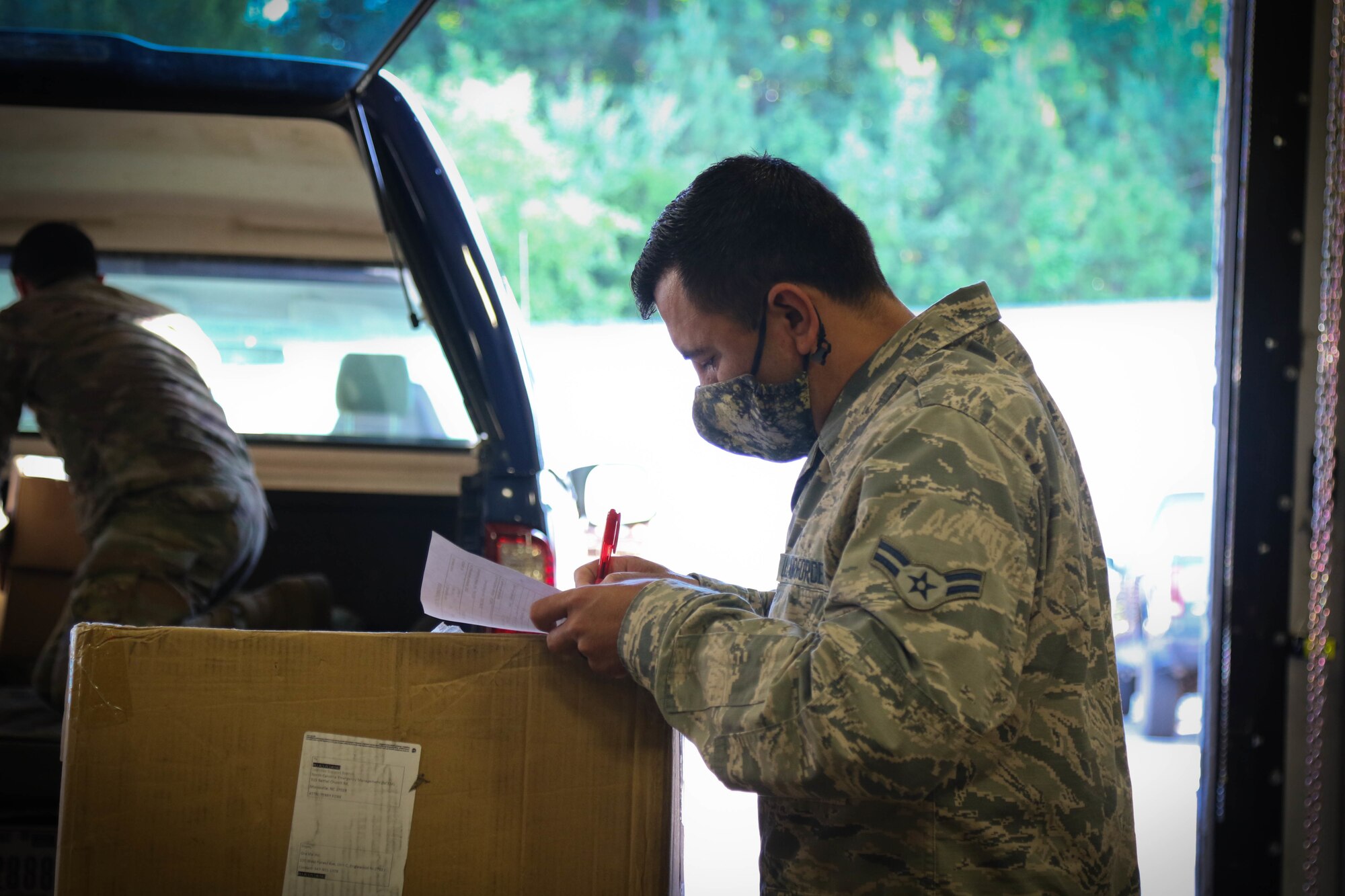 North Carolina Air National Guard Airman 1st Class Ricardo Soto, assigned to the 145th Logistics Readiness Squadron, reviews incoming medical supply orders for distribution to public and charter schools in surrounding counties at a warehouse in Central N.C., June 29, 2020. The NCNG is working with North Carolina Emergency Management, N.C. Department of Health and Human Services and local food banks to help support COVID-19 relief efforts. (U.S. Army National Guard photo by Spc. Hannah Tarkelly, 382nd Public Affairs Detachment/Released).
