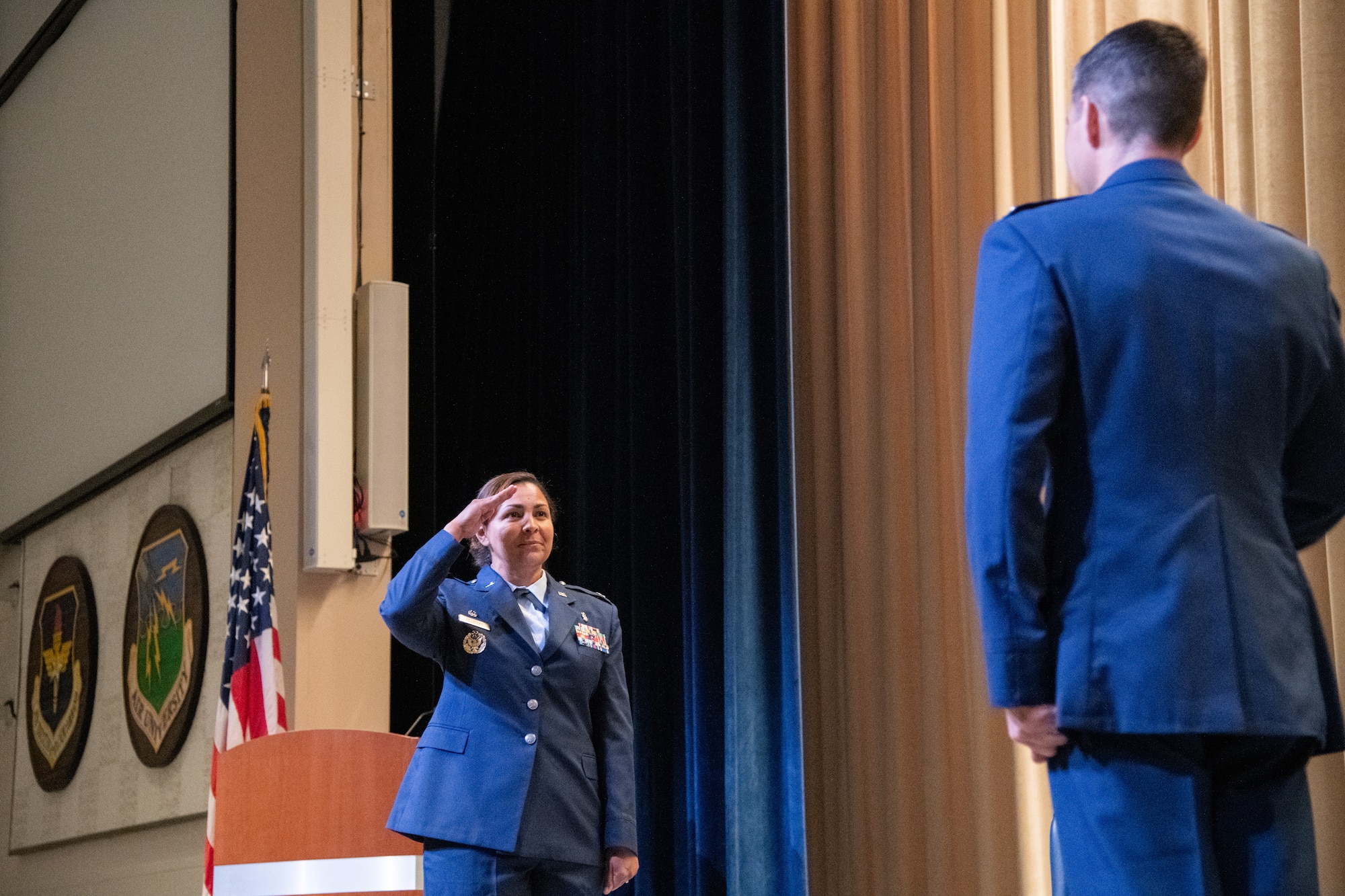 U.S. Air Force Col. Zoya Lee-Zerkel salutes Col. Patrick Carley during a change of command ceremony July 1, 2020,Maxwell Air Force Base, Alabama. Lee-Zerkel is taking over command of the 42nd Medical Group after serving as commander of the 86th Medical Group Expeditionary Medical Support stationed on Ramstein Air Base, Germany. (U.S. Air Force photo by William Birchfield)