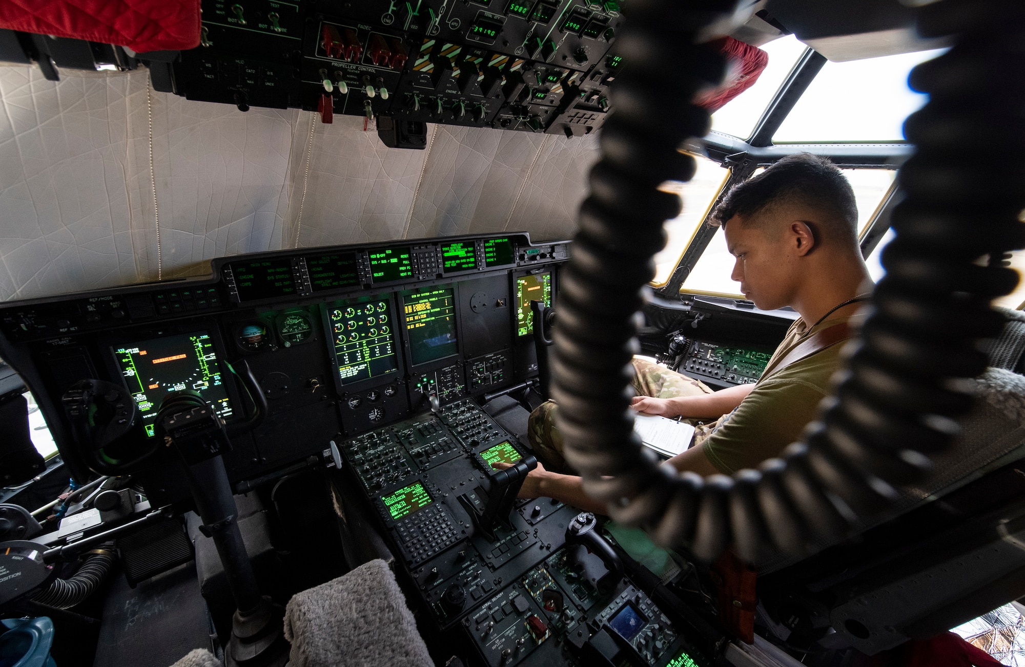 A U.S. Air Force 75th Expeditionary Airlift Squadron (EAS) loadmaster reviews a checklist on a C-130J Super Hercules at Camp Lemonnier, Djibouti, June 28, 2020. The 75th EAS provides strategic airlift capabilities across the Combined Joint Task Force - Horn of Africa (CJTF-HOA) area of responsibility. (U.S. Air Force photo by Tech. Sgt. Christopher Ruano)