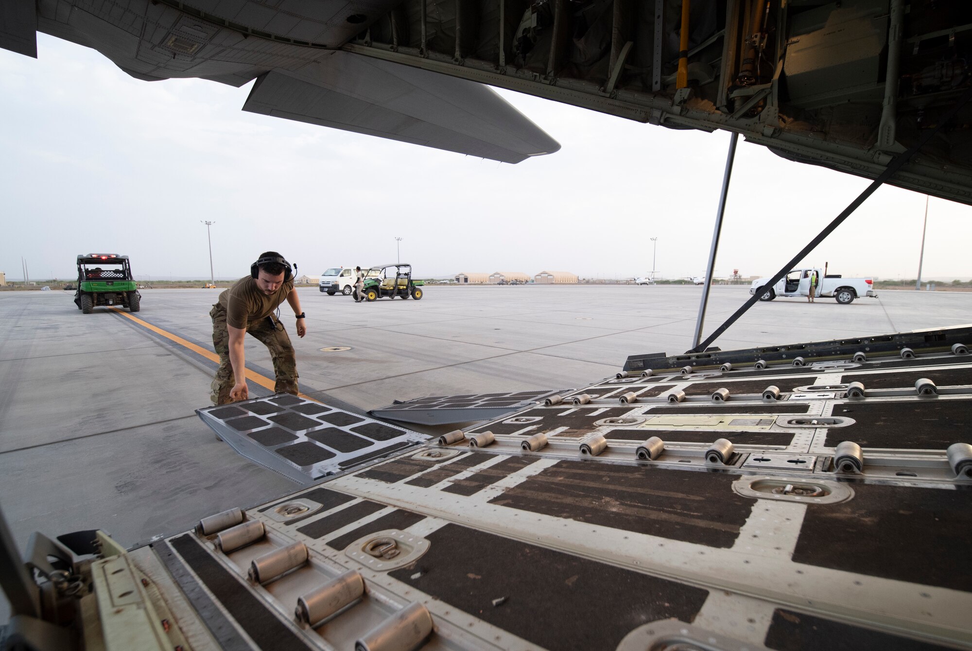 A U.S. Air Force 75th Expeditionary Airlift Squadron (EAS) loadmaster prepares vehicle ramps on a C-130J Super Hercules at Camp Lemonnier, Djibouti, June 28, 2020. The 75th EAS provides strategic airlift capabilities across the Combined Joint Task Force - Horn of Africa (CJTF-HOA) area of responsibility. (U.S. Air Force photo by Tech. Sgt. Christopher Ruano)