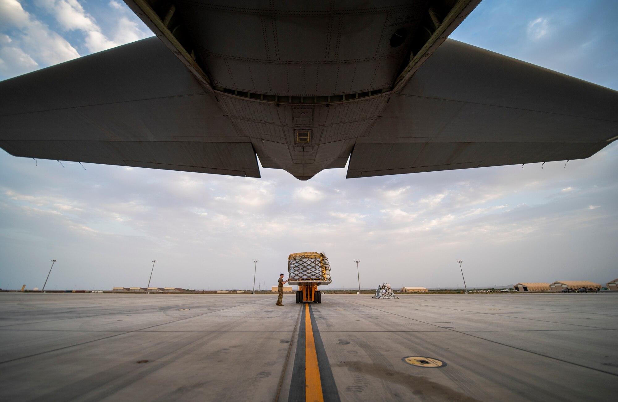 Cargo is loaded onto a U.S. Air Force C-130J Super Hercules assigned to the 75th Expeditionary Airlift Squadron (EAS) at Camp Lemonnier, Djibouti, June 28, 2020. The 75th EAS provides strategic airlift capabilities across the Combined Joint Task Force - Horn of Africa (CJTF-HOA) area of responsibility. (U.S. Air Force photo by Tech. Sgt. Christopher Ruano)