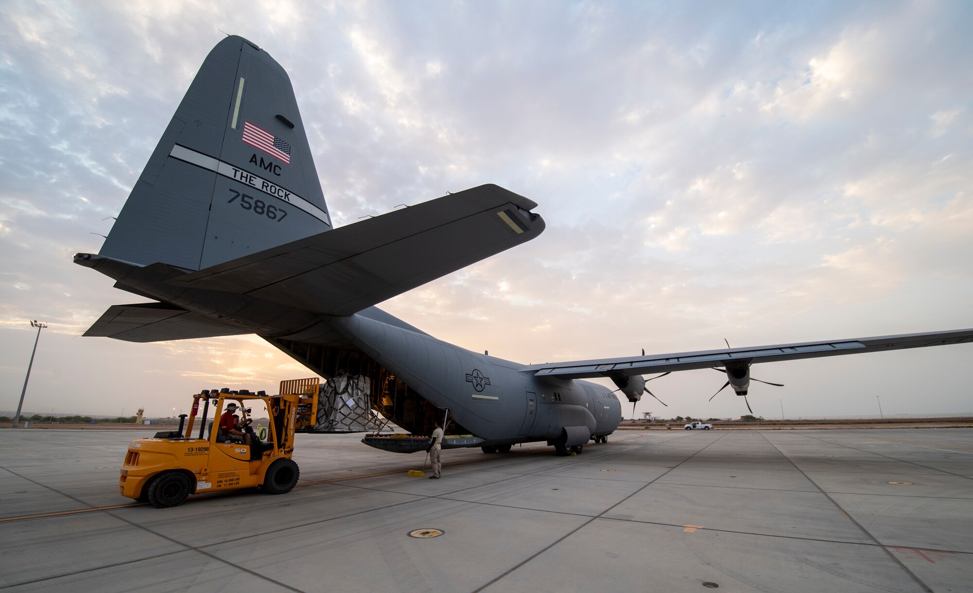 Cargo is loaded onto a U.S. Air Force C-130J Super Hercules assigned to the 75th Expeditionary Airlift Squadron (EAS) at Camp Lemonnier, Djibouti, June 28, 2020. The 75th EAS provides strategic airlift capabilities across the Combined Joint Task Force - Horn of Africa (CJTF-HOA) area of responsibility. (U.S. Air Force photo by Tech. Sgt. Christopher Ruano)