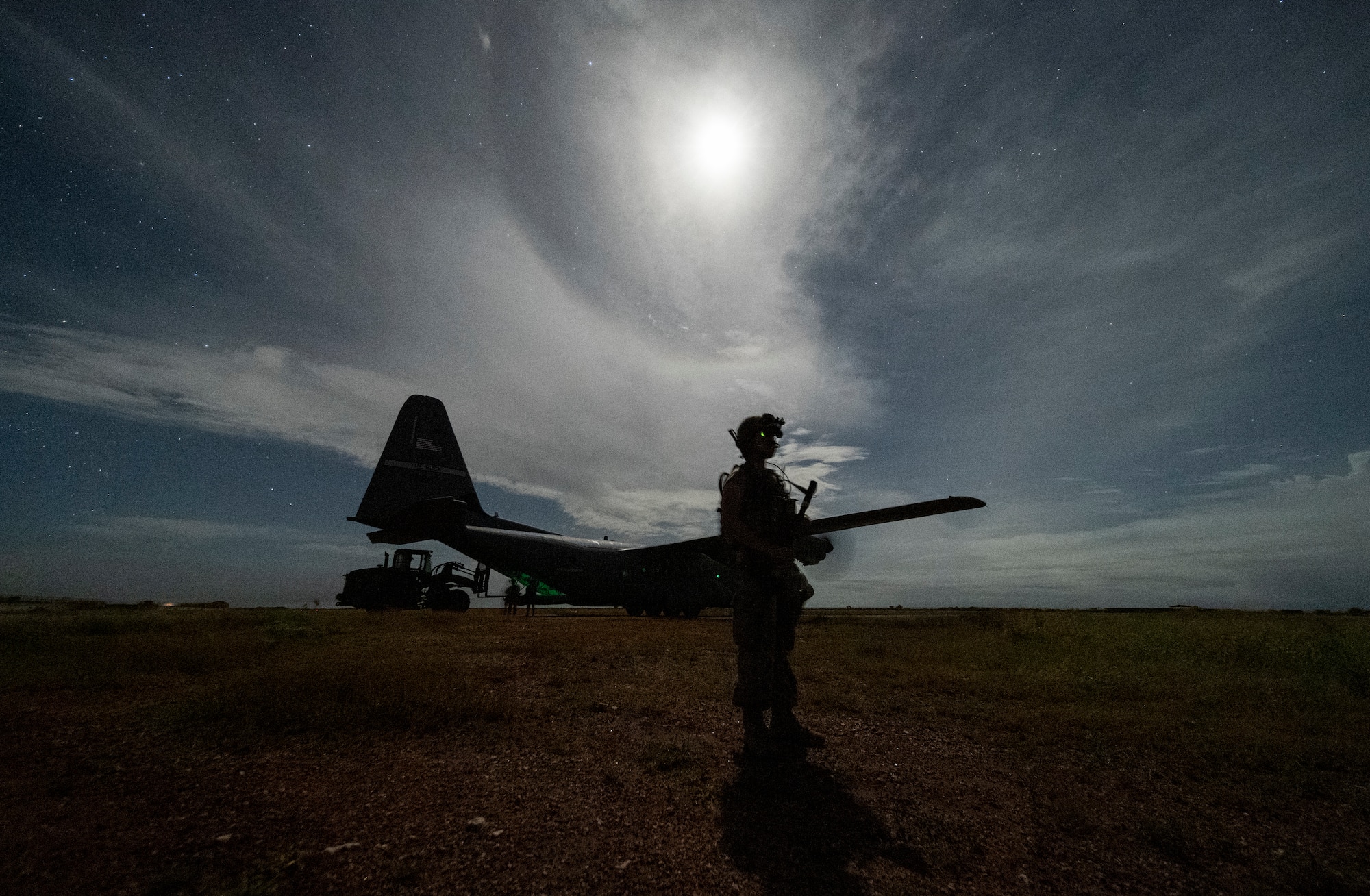 U.S. Army Spc. Alexander Nguyen, combat medic specialist, assigned to the 1-186th Infantry Battalion, Task Force Guardian, Combined Joint Task Force – Horn of Africa (CJTF-HOA), provides security for a 75th Expeditionary Airlift Squadron (EAS) C-130J Super Hercules during unloading operations in Somalia, June 28, 2020. Task Force Guardian provides base security and force protection for CJFT-HOA personnel and U.S. partner forces deployed in the region. (U.S. Air Force photo by Tech. Sgt. Christopher Ruano)