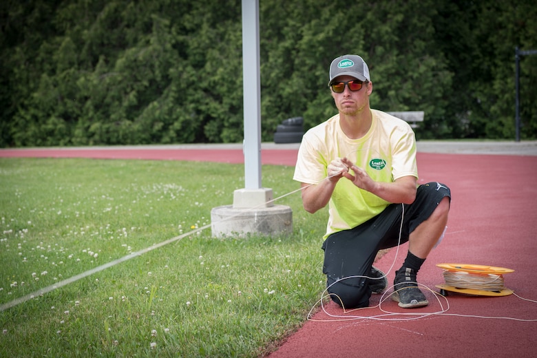 Zach Neilsen, a Grissom contractor, places line guides on Grissom’s running track after being resurfaced June 3, 2020.