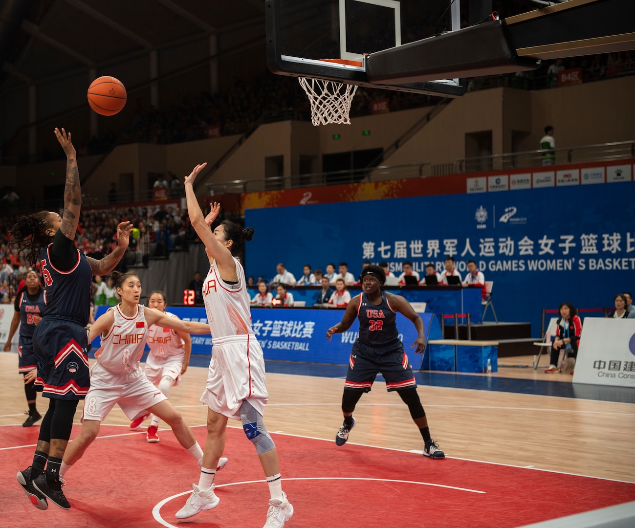 U.S. Navy Petty Officer 2nd Class Ariel Thomas, United States Armed Forces Military World Games Women’s Basketball player, shoots a basket over a Chinese defender during the Conseil International du Sport Militaire Women’s Basketball Competion in Wuhan China, Oct. 22, 2019. The 7th MWG will feature military athletes from around the world with an estimated participation of more than 100 nations and more than 10,000 participants. (U.S. Air Force photo by Staff Sergeant James R. Crow)