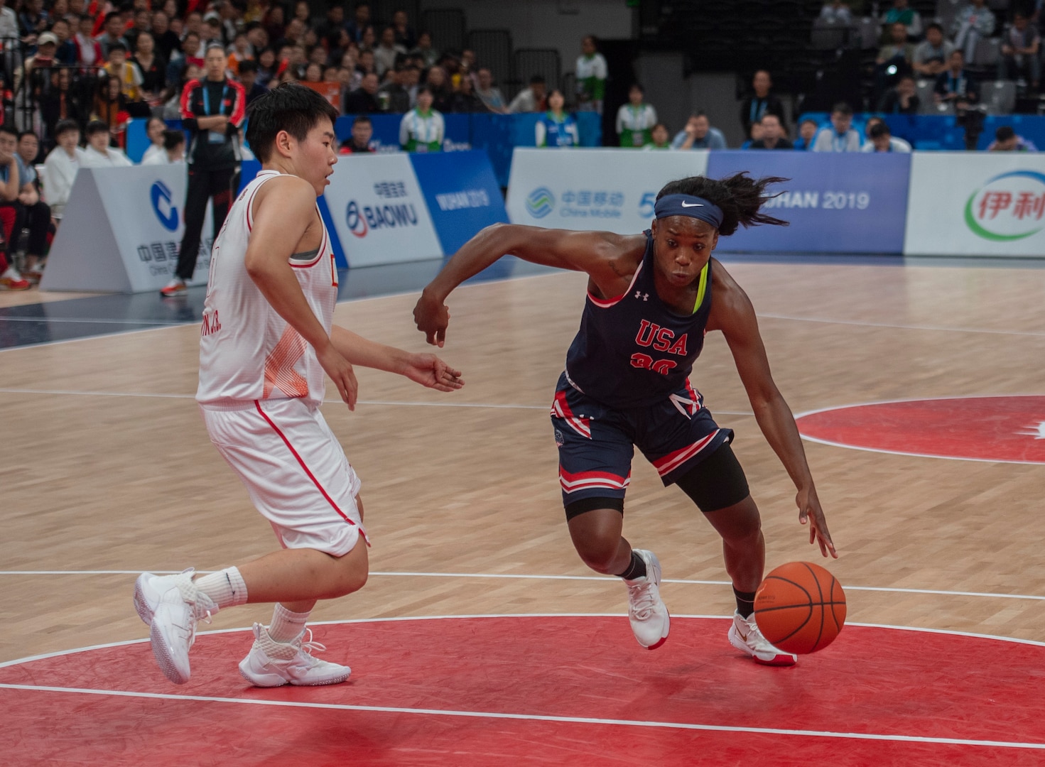 U.S. Army Sgt. Donita Adams, United States Armed Forces Military World Games Women’s Basketball player, drives past a Chinese defender during the Conseil International du Sport Militaire Women’s Basketball Competion in Wuhan China, Oct. 22, 2019. The 7th MWG will feature military athletes from around the world with an estimated participation of more than 100 nations and more than 10,000 participants. (U.S. Air Force photo by Staff Sergeant James R. Crow)