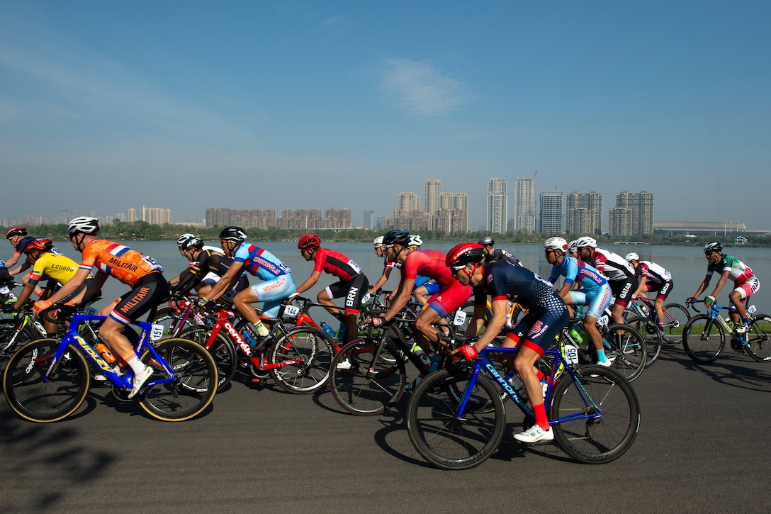 U.S. Air Force Capt. Stefan Zavislan of the U.S. Armed Forces Men’s Cycling Team, front, races on the shores of East Lake during the men’s cycling road race of the 2019 CISM Military World Games in Wuhan, China Oct. 21, 2019. More than 100 teams are competing in 32 sports in the for the Conseil International du Sport Militaire (Council of International Military.) (DoD photo by EJ Hersom)