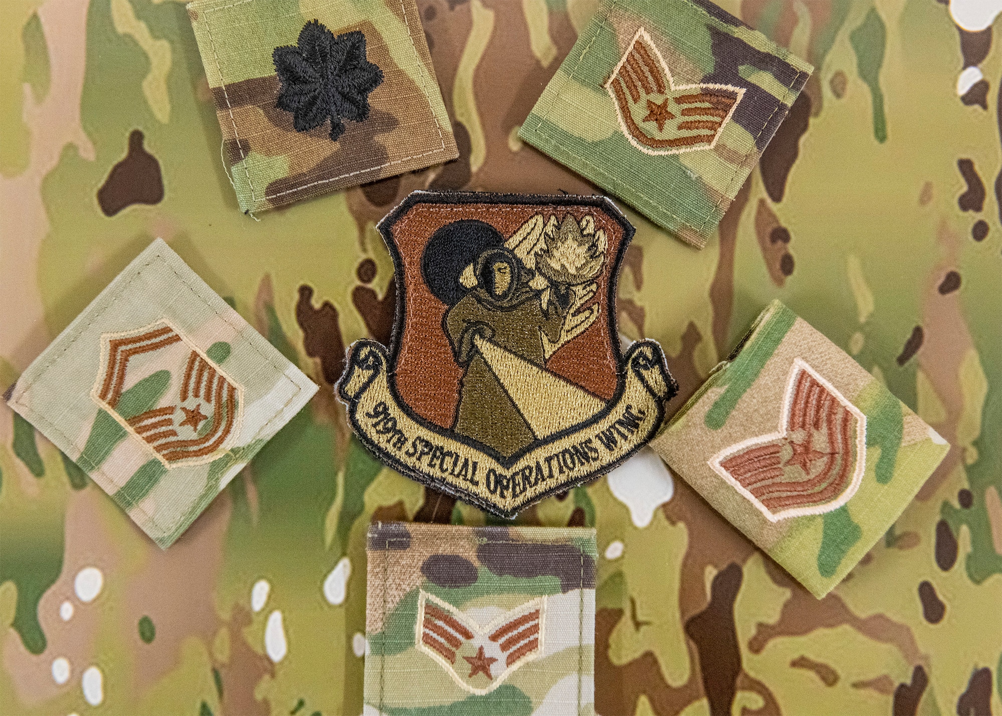 A 919th Special Operations Wing patch sits on an operational camouflage pattern backdrop at Duke Field, July 7, 2020. (U.S. Air Force photo by Senior Airman Dylan Gentile)