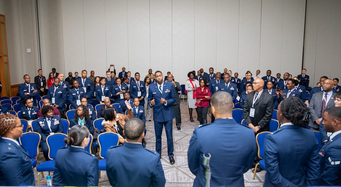 An Air Force Officer speaks to a group of people at a conference