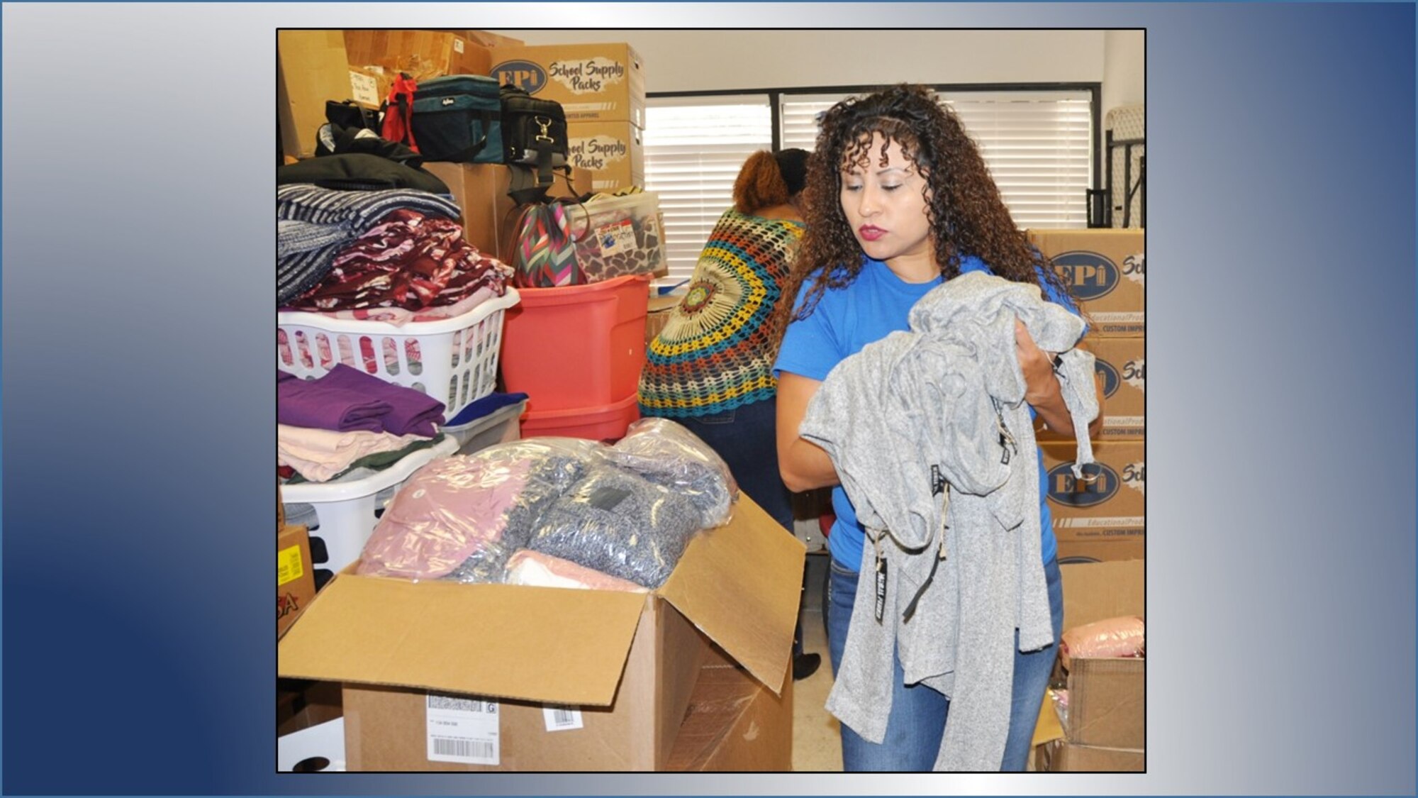 Master Sgt. Julia Tovar sorts clothing during a 340th Flying Training Group community outreach event Sept. 11 at the San Antonio, Texas Family Violence Prevention Services/Battered Women and Children’s Shelter’s Donation Center. (U.S. Air Force graphic by Janis El Shabazz)