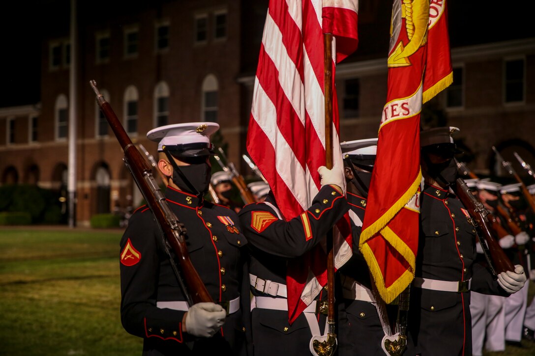 Marines with the Official U.S. Marine Corps Color Guard execute “pass in review” during a Friday Evening Parade at Marine Barracks Washington, D.C., July 3, 2020. The Honorable Mr. Kenneth Braithwaite, Secretary of the Navy, was the guest of honor, and the 38th Commandant of the Marine Corps, Gen. David H. Berger, was the hosting official. (U.S. Marine Corps Photo by Cpl. James Bourgeois)