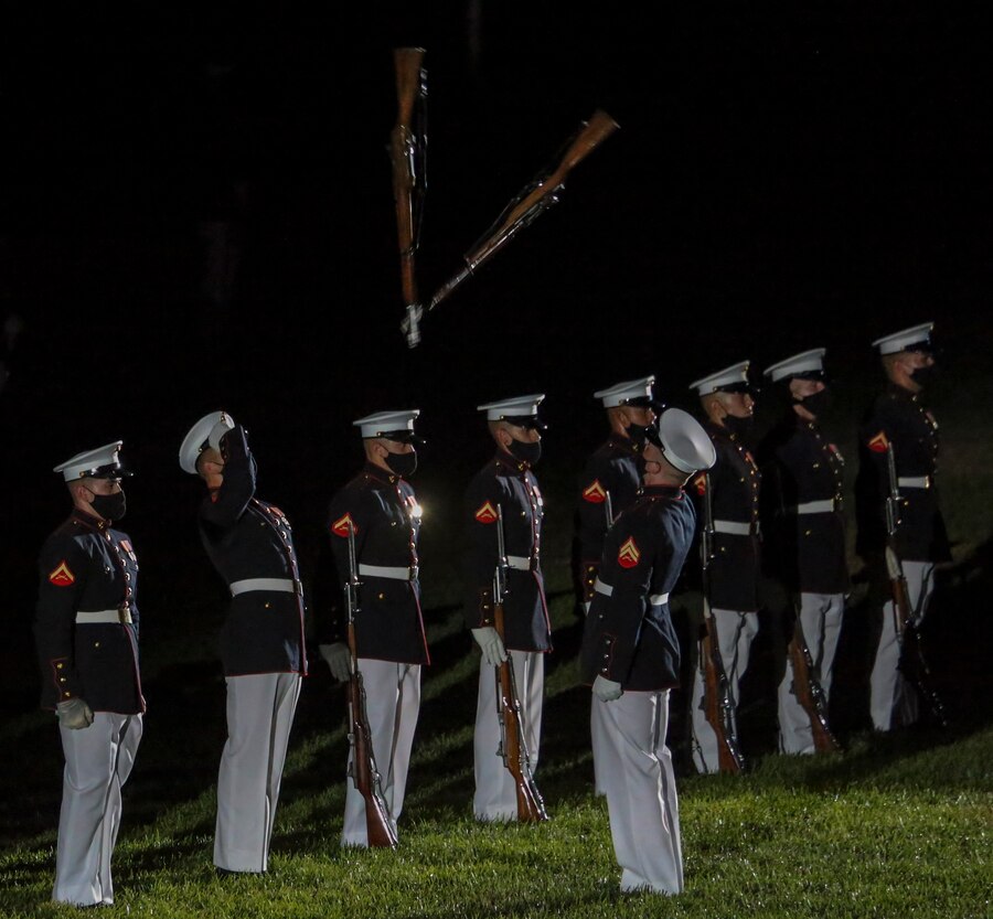 Marines with the Silent Drill Platoon perform their “rifle inspection” sequence during a Friday Evening Parade at Marine Barracks Washington, D.C., July 3, 2020. The Honorable Mr. Kenneth Braithwaite, Secretary of the Navy, was the guest of honor, and the 38th Commandant of the Marine Corps, Gen. David H. Berger, was the hosting official. (U.S. Marine Corps Photo by Lance Cpl. Allen Sanders)