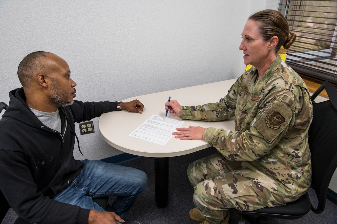 Master Sgt. Tracey Riley, 403rd Wing Career Assistance Advisor, briefs Master Sgt. Joshua Powell, 403rd Maintenance Squadron aircraft hydraulics technician, about his reenlistment extension paperwork July 1, 2020, at Keesler Air Force Base, Mississippi. As an advisor, she can serve as a resource to assist Airmen in reaching their goals and career destinations. (U.S. Air Force photo by Tech. Sgt. Christopher Carranza)