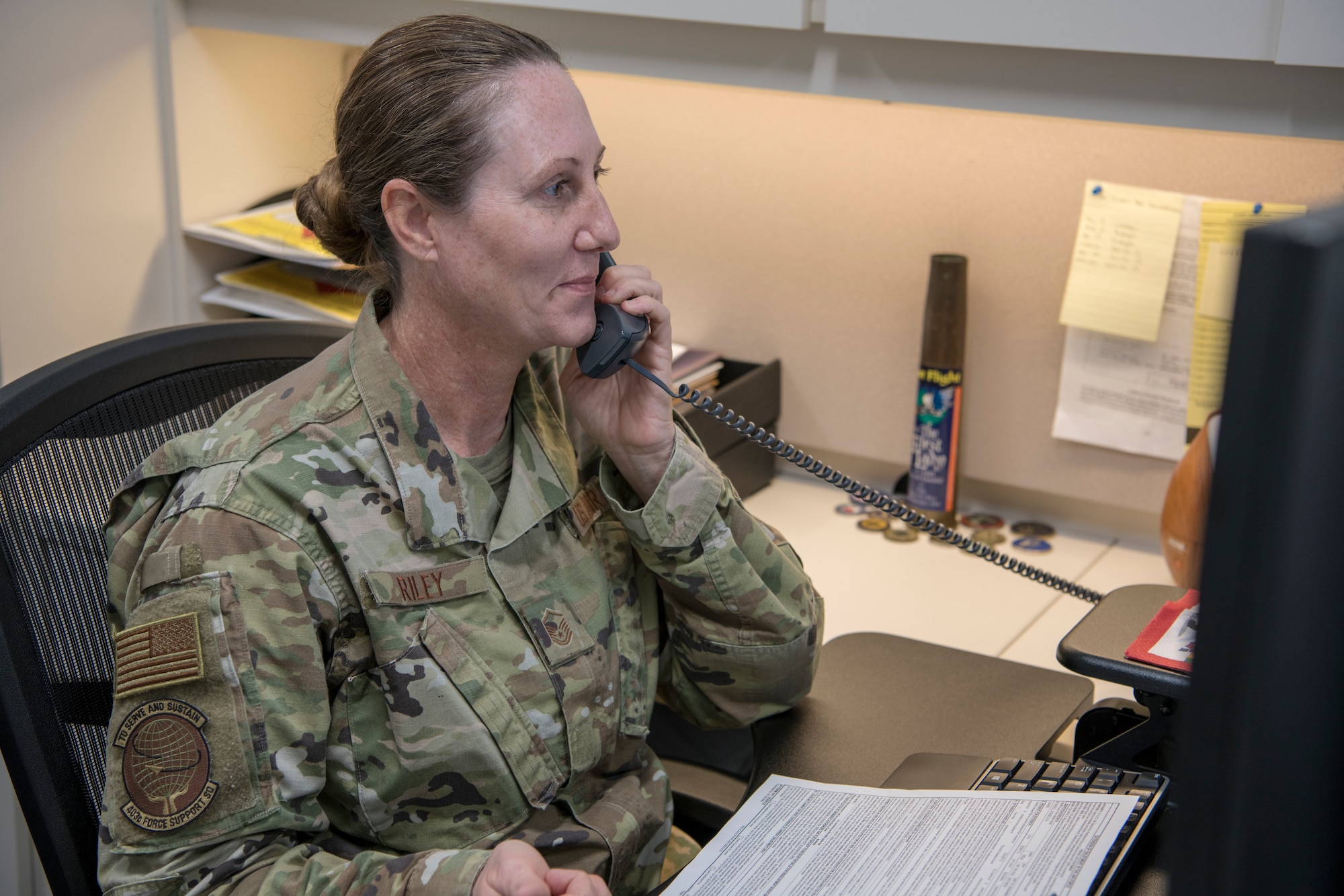 Master Sgt. Tracey Riley, 403rd Wing career advisor, answers a customer’s question about the reenlistment process  July 1 at Keesler Air Force Base, Mississippi. As an advisor, she can serve as a resource to assist Airmen in reaching their goals and career destinations. (U.S. Air Force photo by Tech. Sgt. Christopher Carranza)