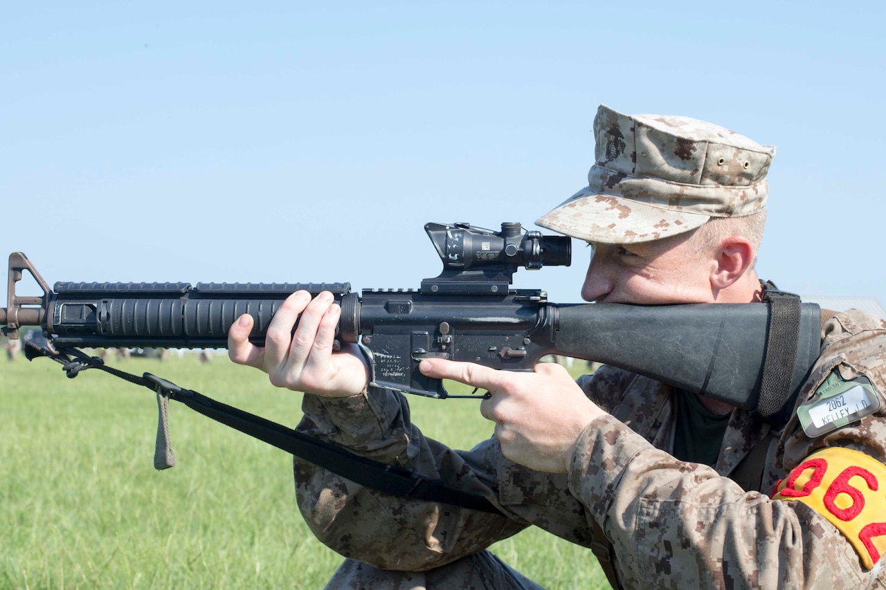 A Marine recruit prepares to fire a rifle.