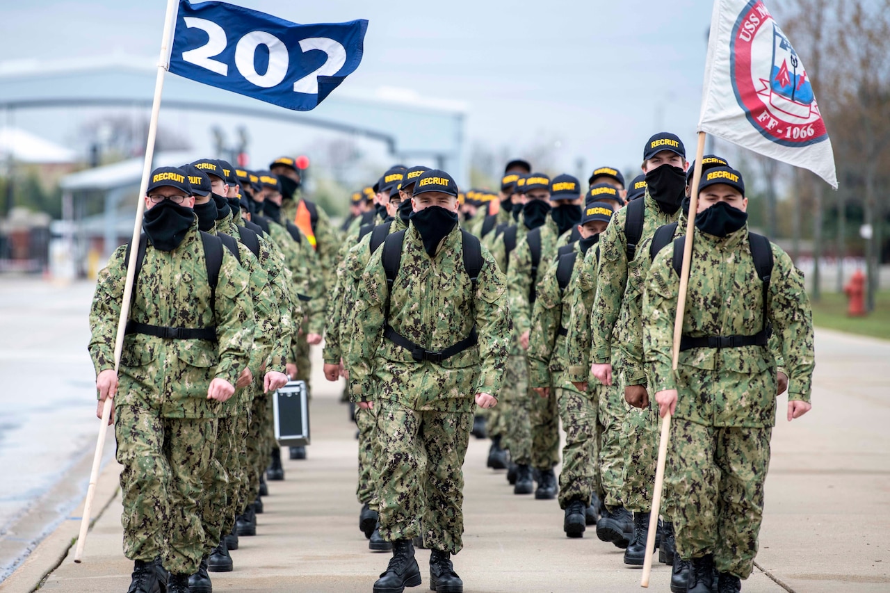 Navy recruits march in formation.